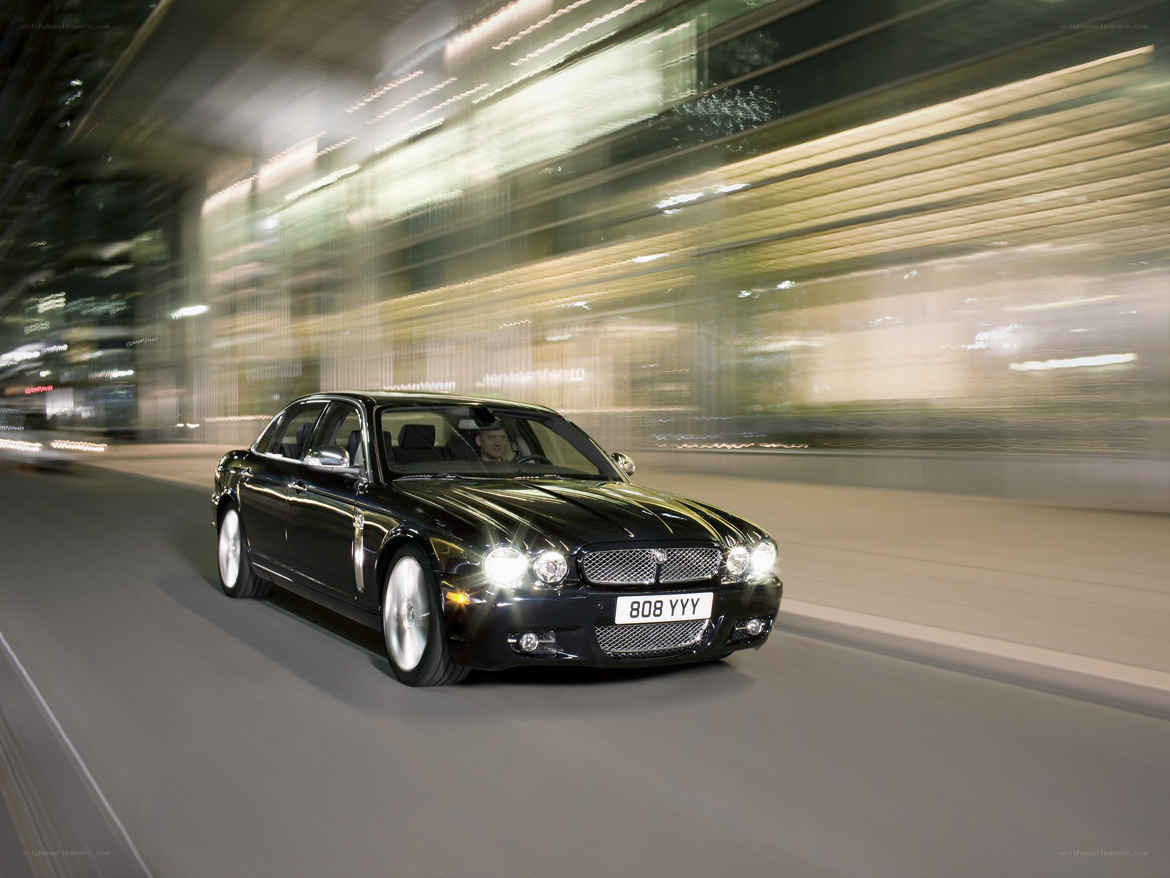 Black luxury car in motion