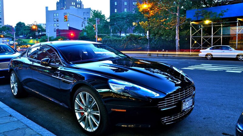 Black luxury car on city street
