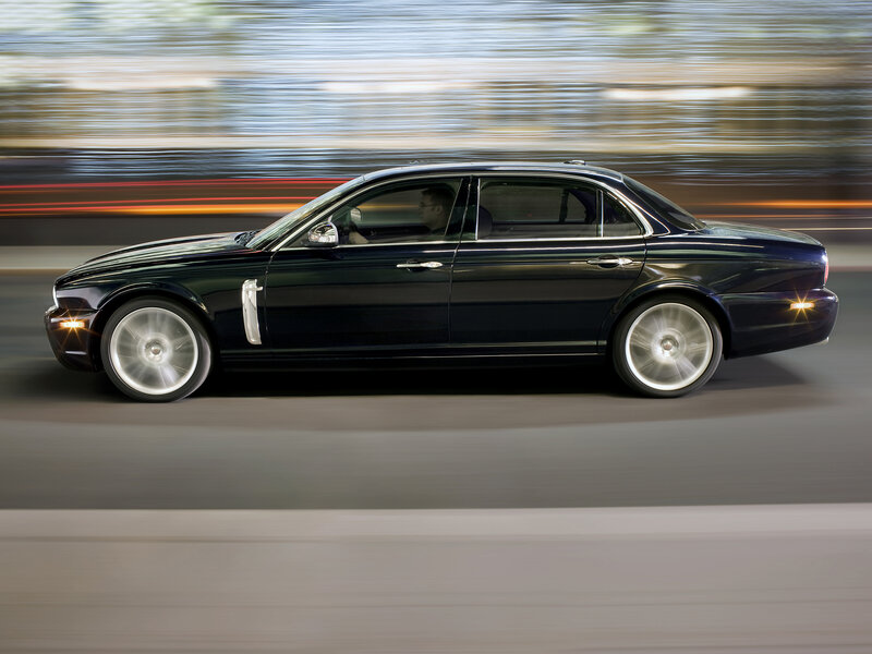 Black luxury sedan in motion