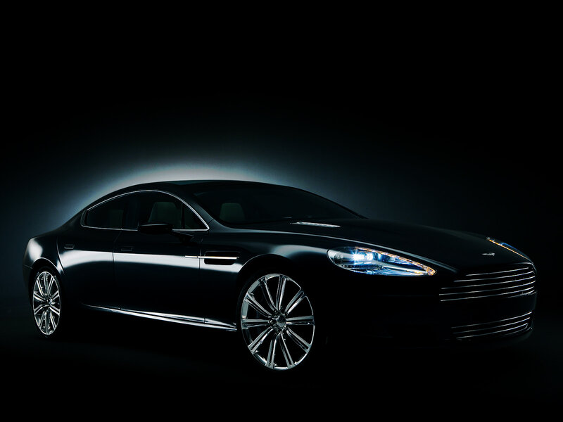 Black luxury sedan in spotlight