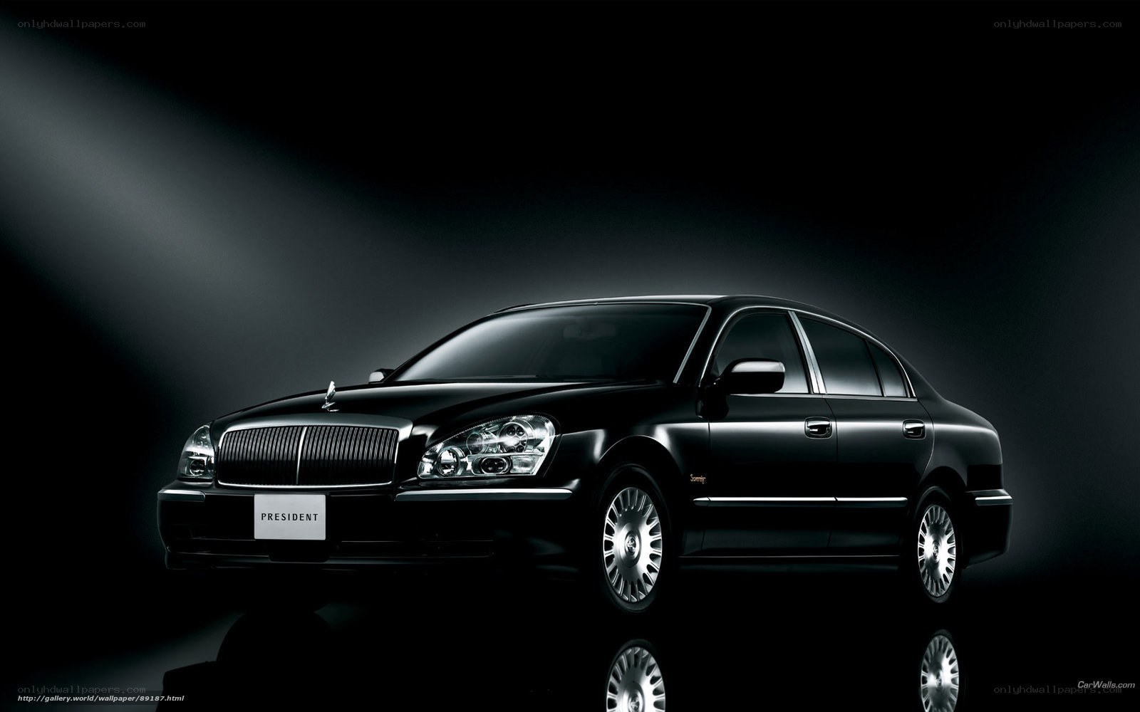 Black luxury sedan in spotlight