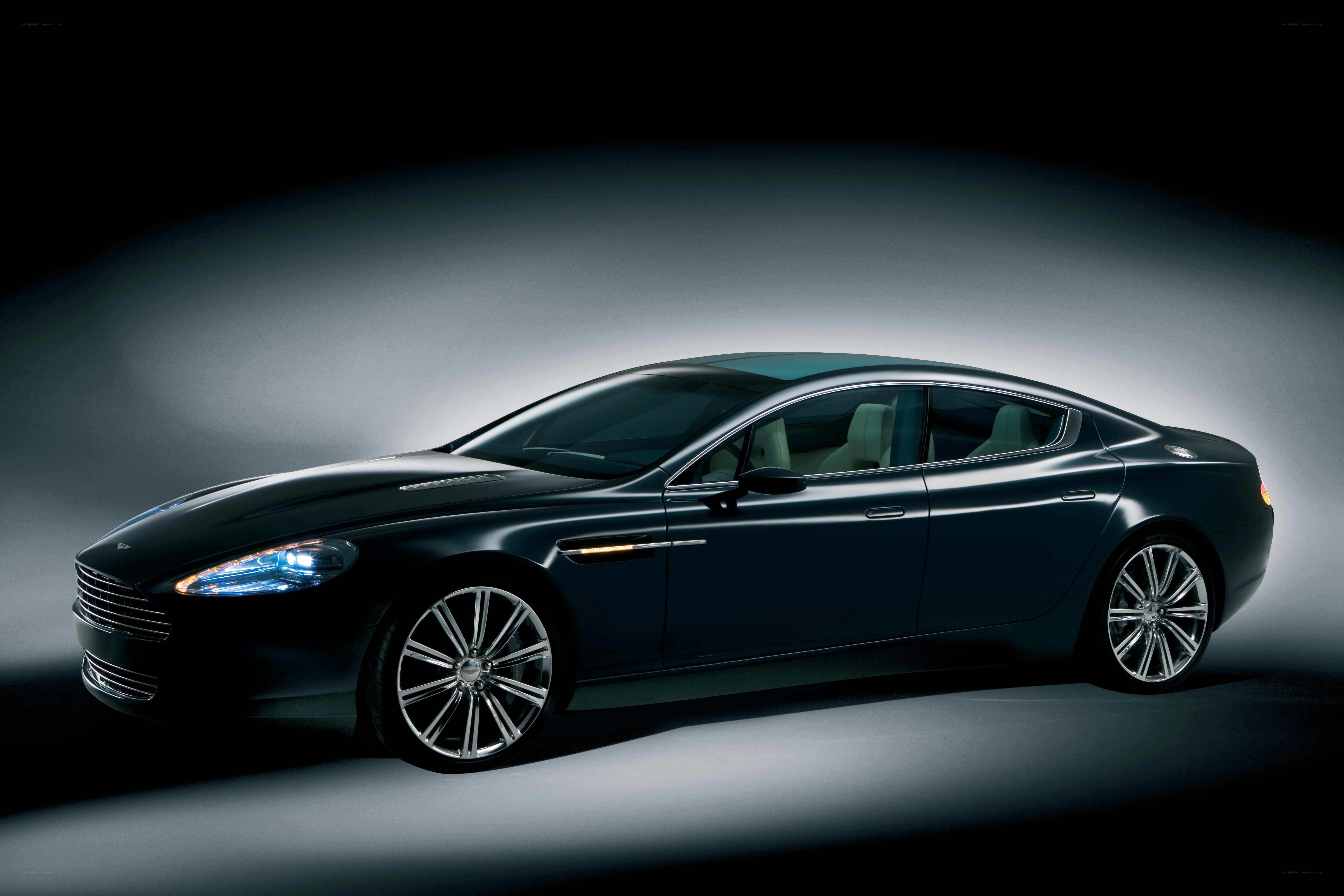 Black luxury sedan in studio