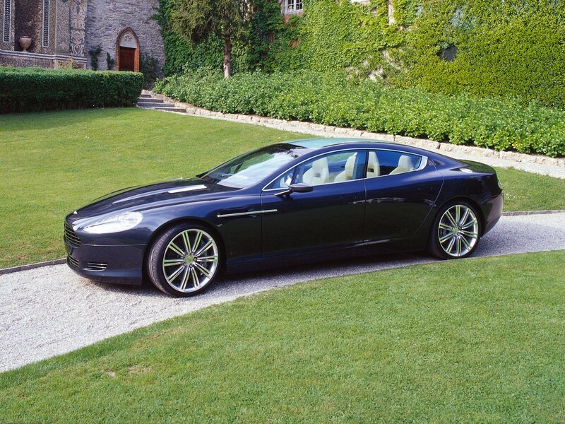 Black luxury sedan on gravel path