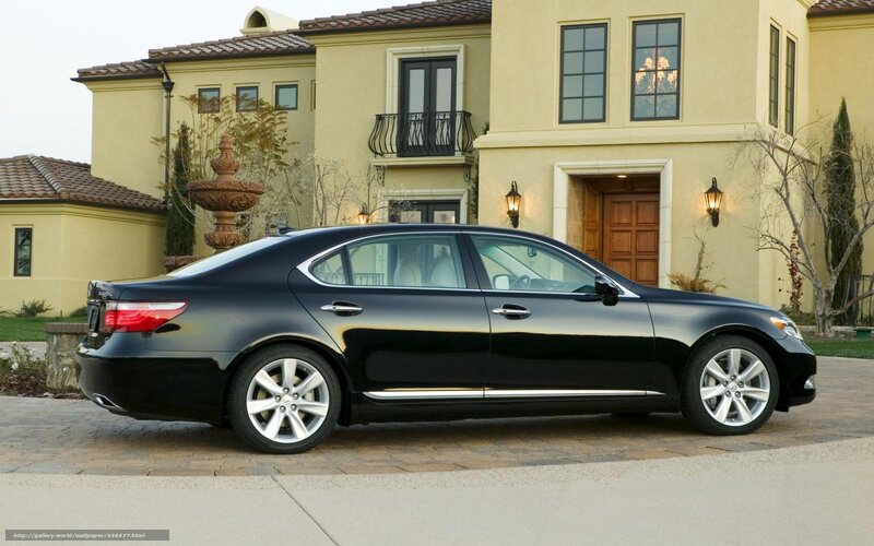 Black luxury sedan parked outside house
