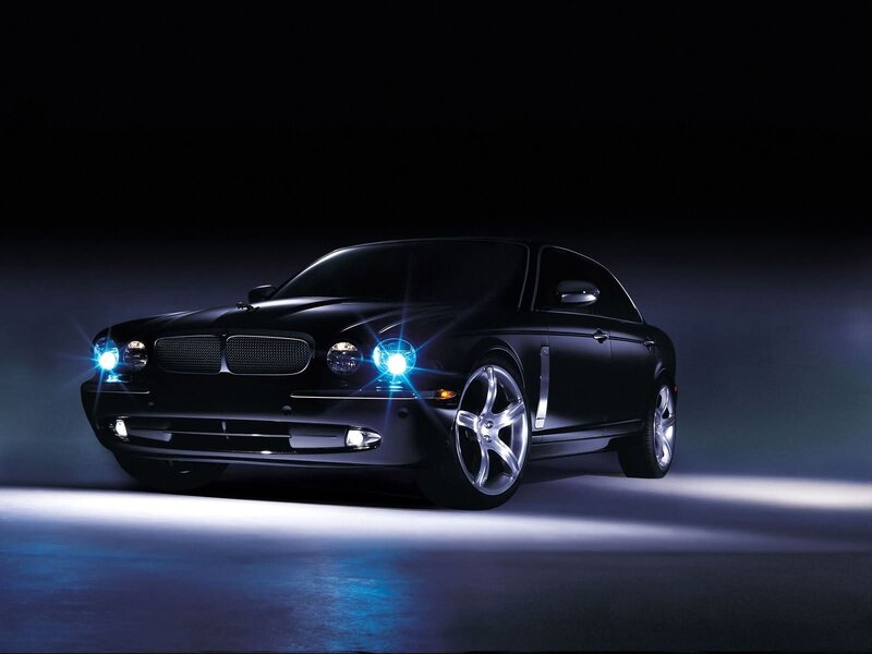Black luxury sedan with blue lights