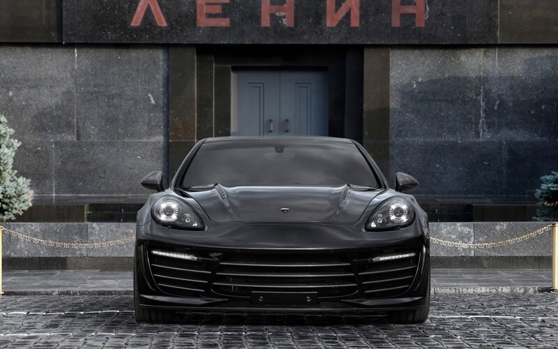 Black luxury sports car in front of building