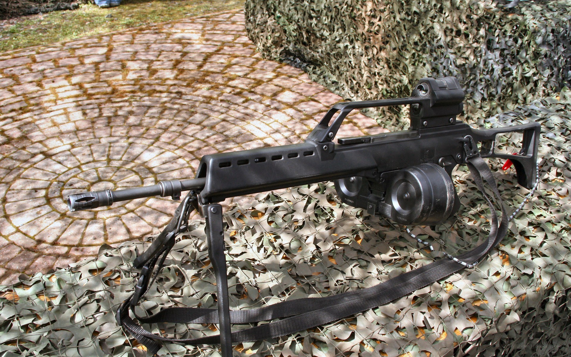 Black machine gun on camouflage