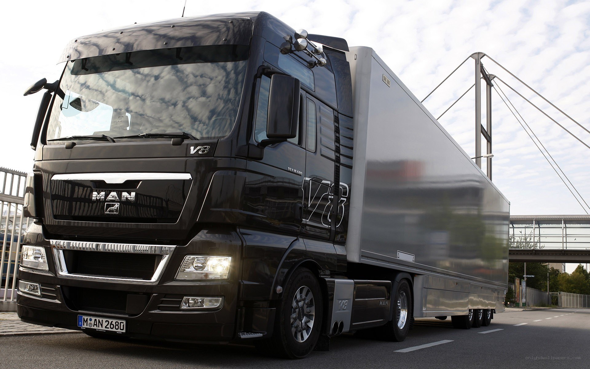 Black MAN V8 truck with trailer