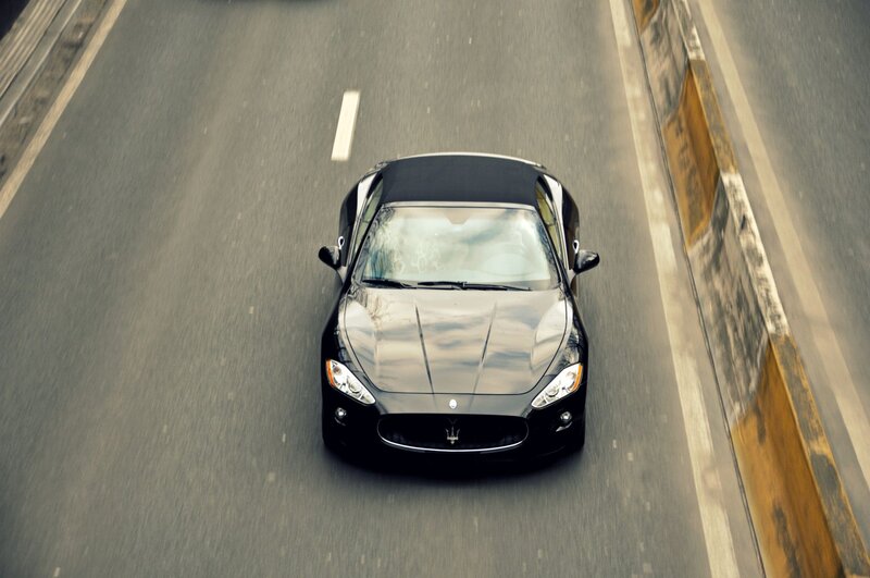 black maserati convertible on road