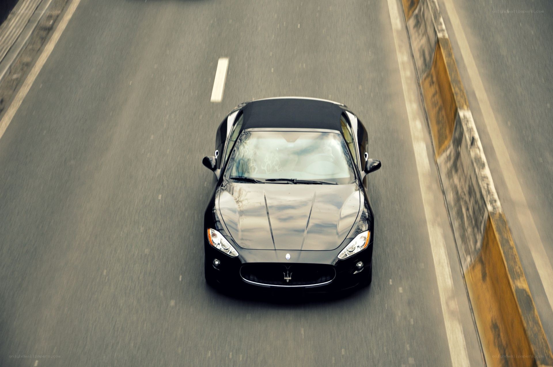 black maserati convertible on road