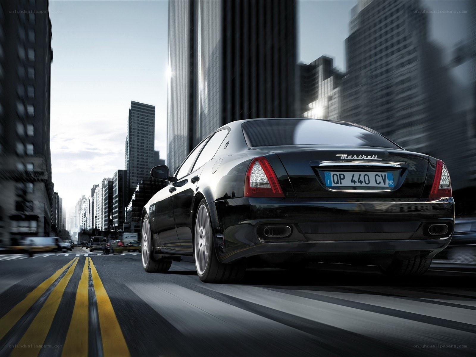 Black Maserati driving in city