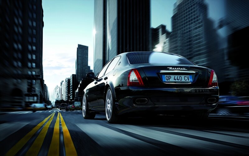 Black Maserati driving in city