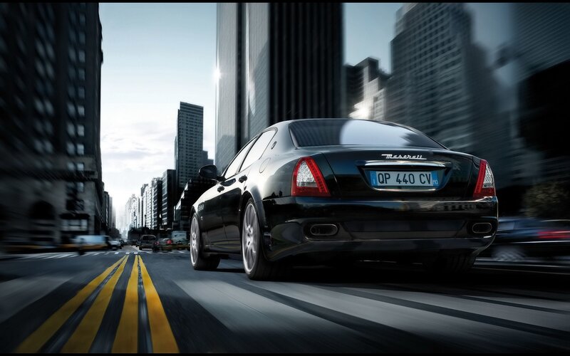 Black Maserati driving in city