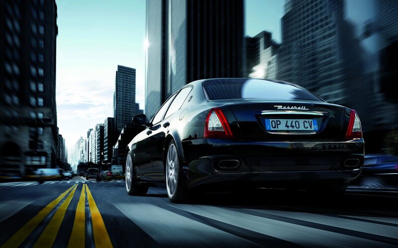 Black Maserati driving in city