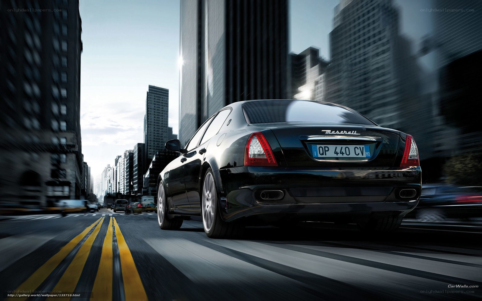 Black Maserati driving in city