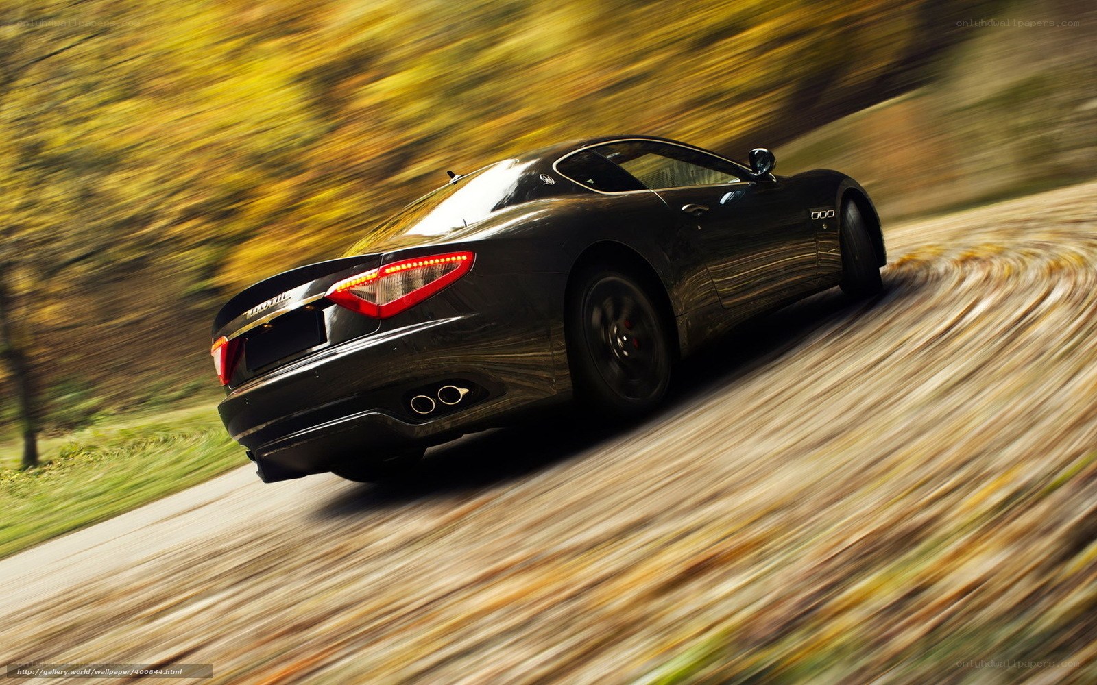 Black Maserati driving on a road