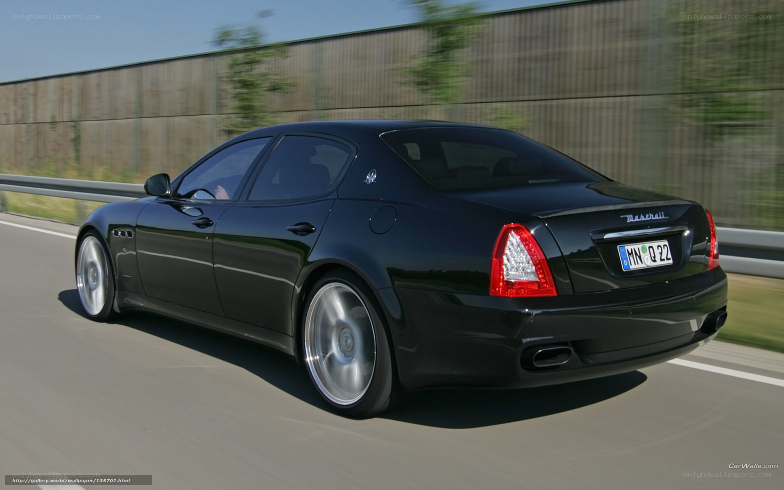 black maserati driving on highway