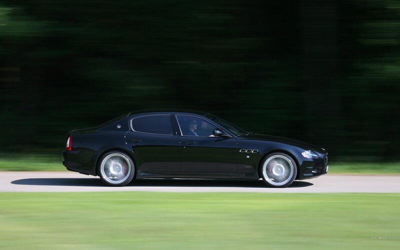 black maserati driving on road
