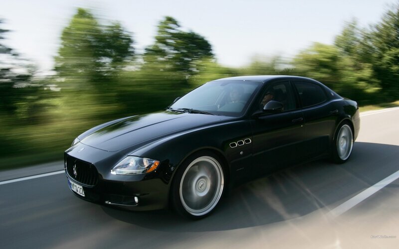 black maserati driving on road