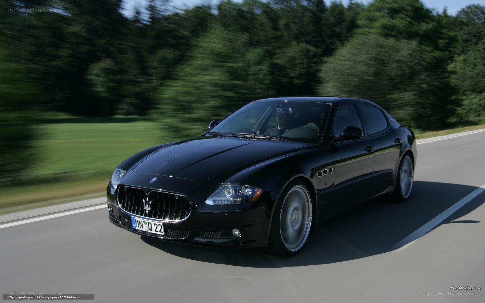black maserati driving on road