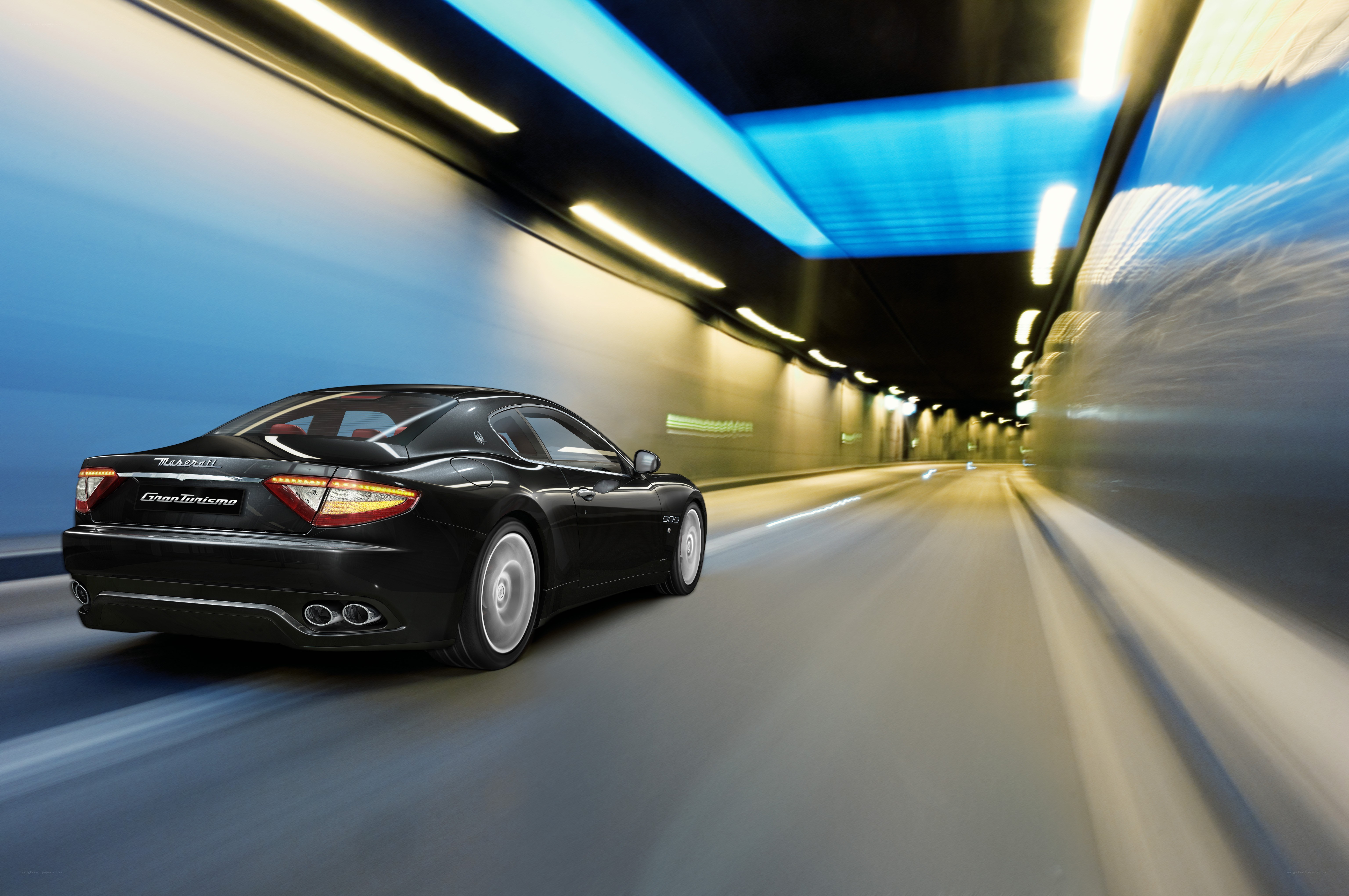 Black Maserati driving through tunnel