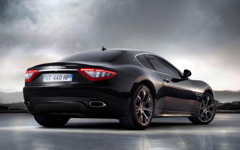 Black Maserati GT in dramatic setting