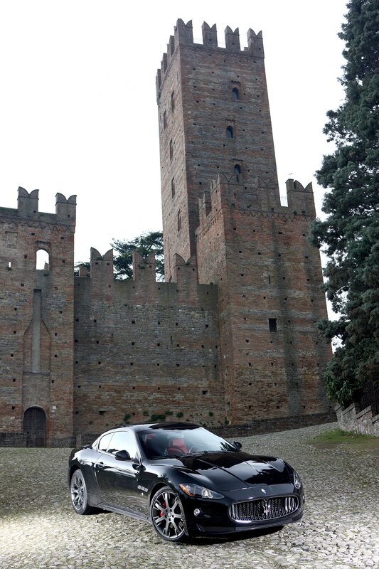 Black Maserati in front of a castle