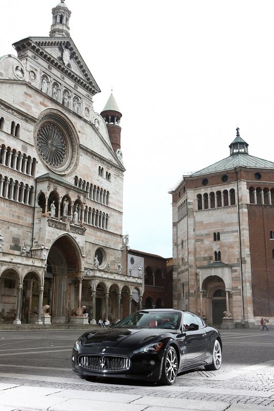 Black Maserati in front of cathedral