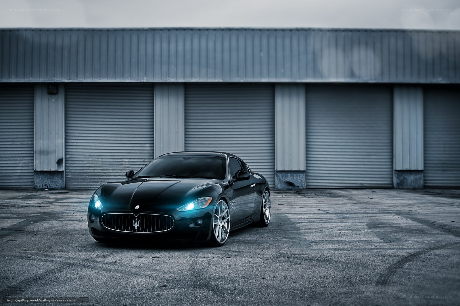 Black Maserati in front of garage
