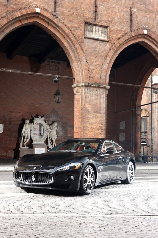 Black Maserati in historic courtyard