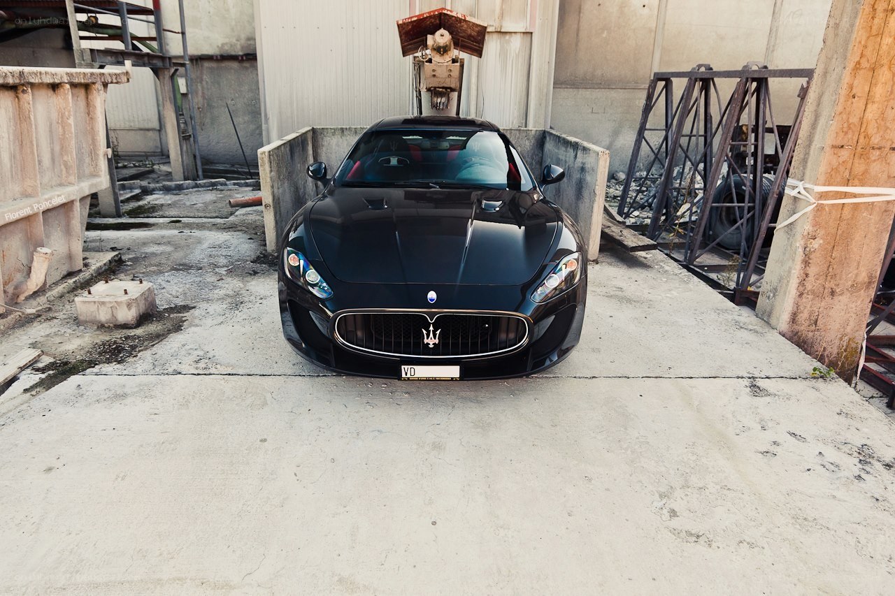 Black Maserati in industrial setting