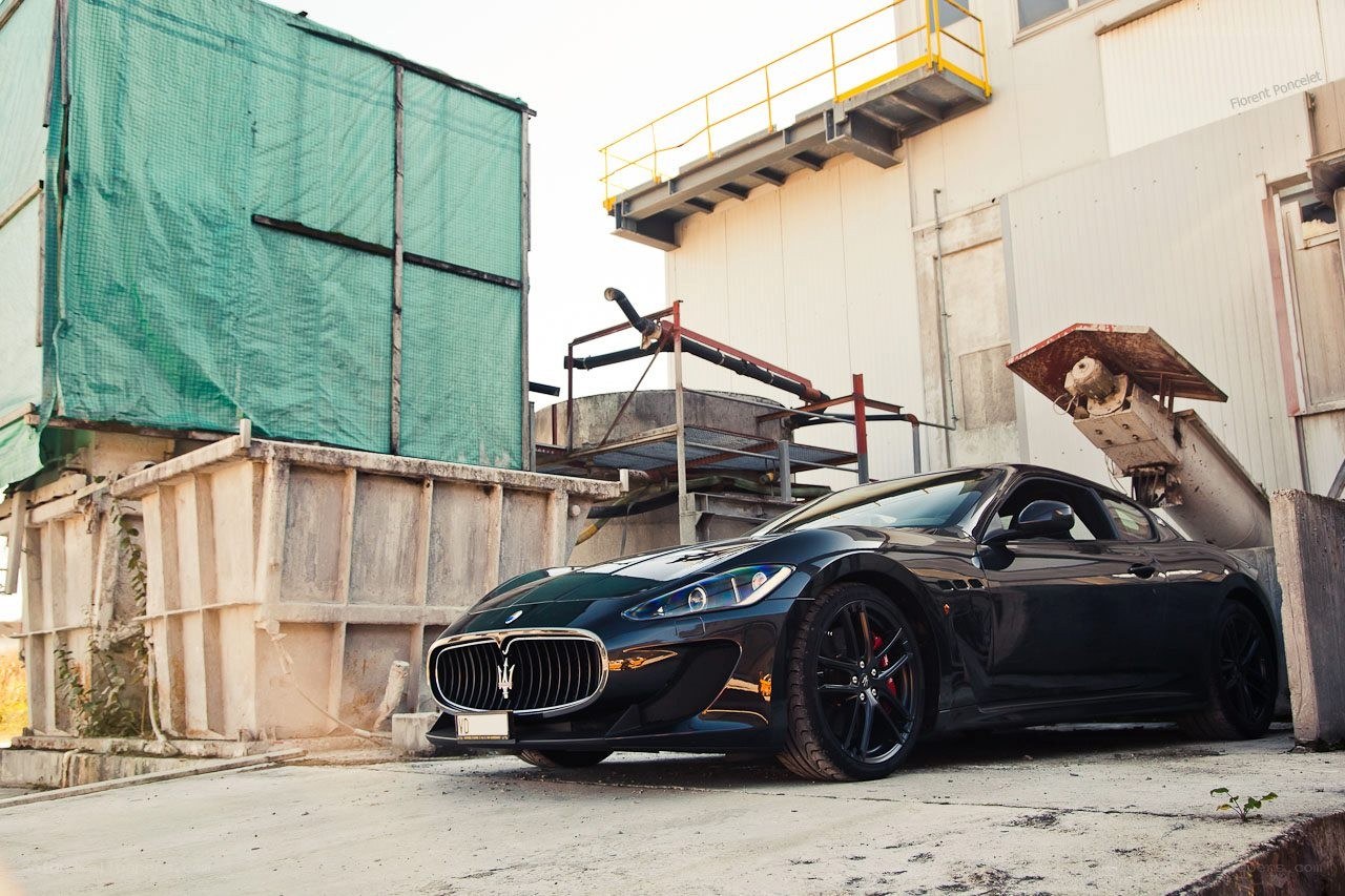 Black Maserati in industrial setting
