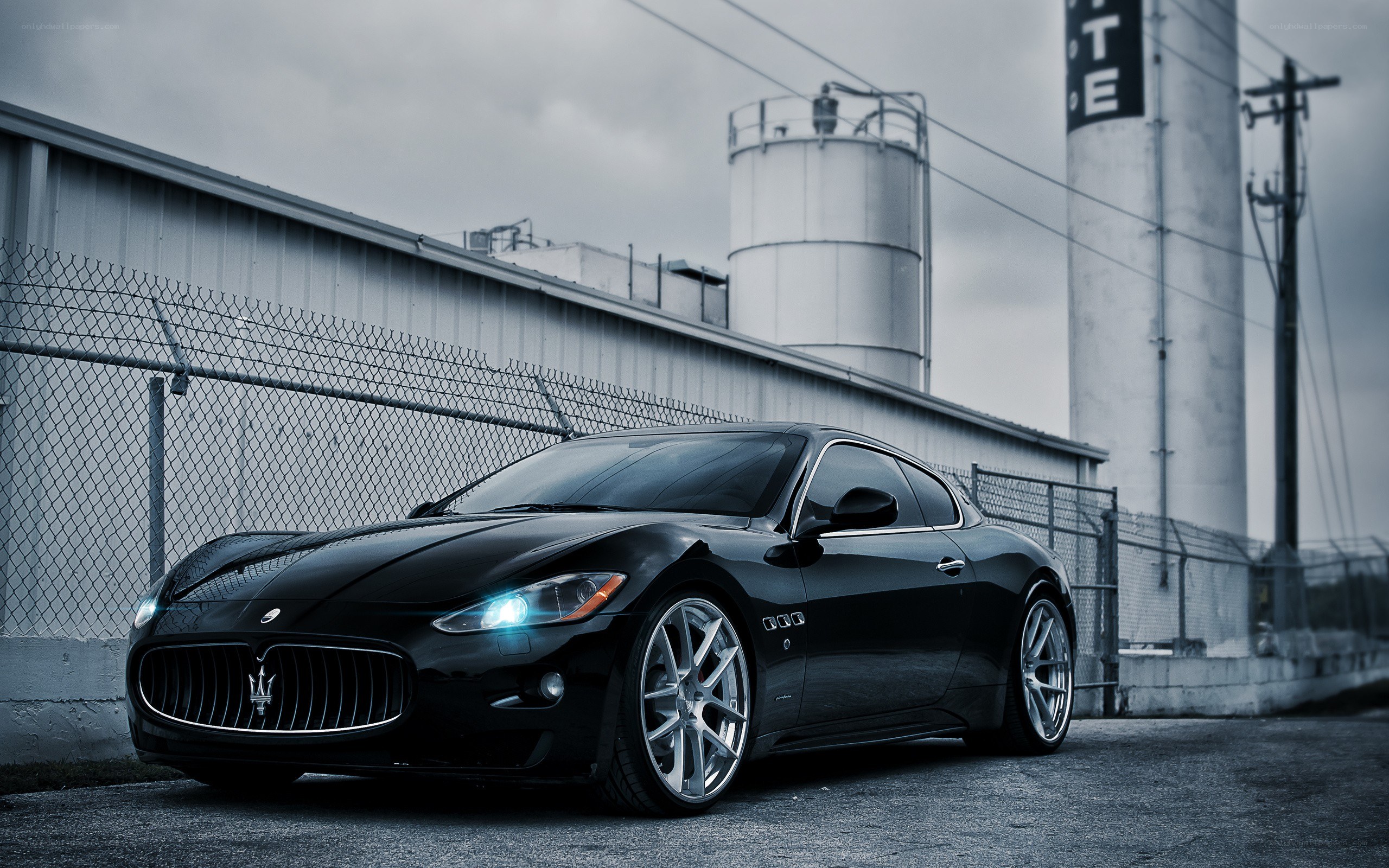 Black Maserati in industrial setting