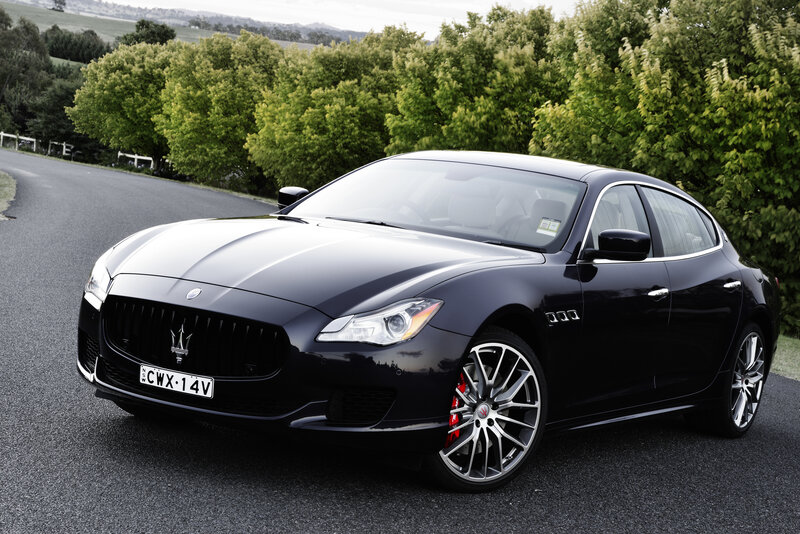 Black Maserati on a country road