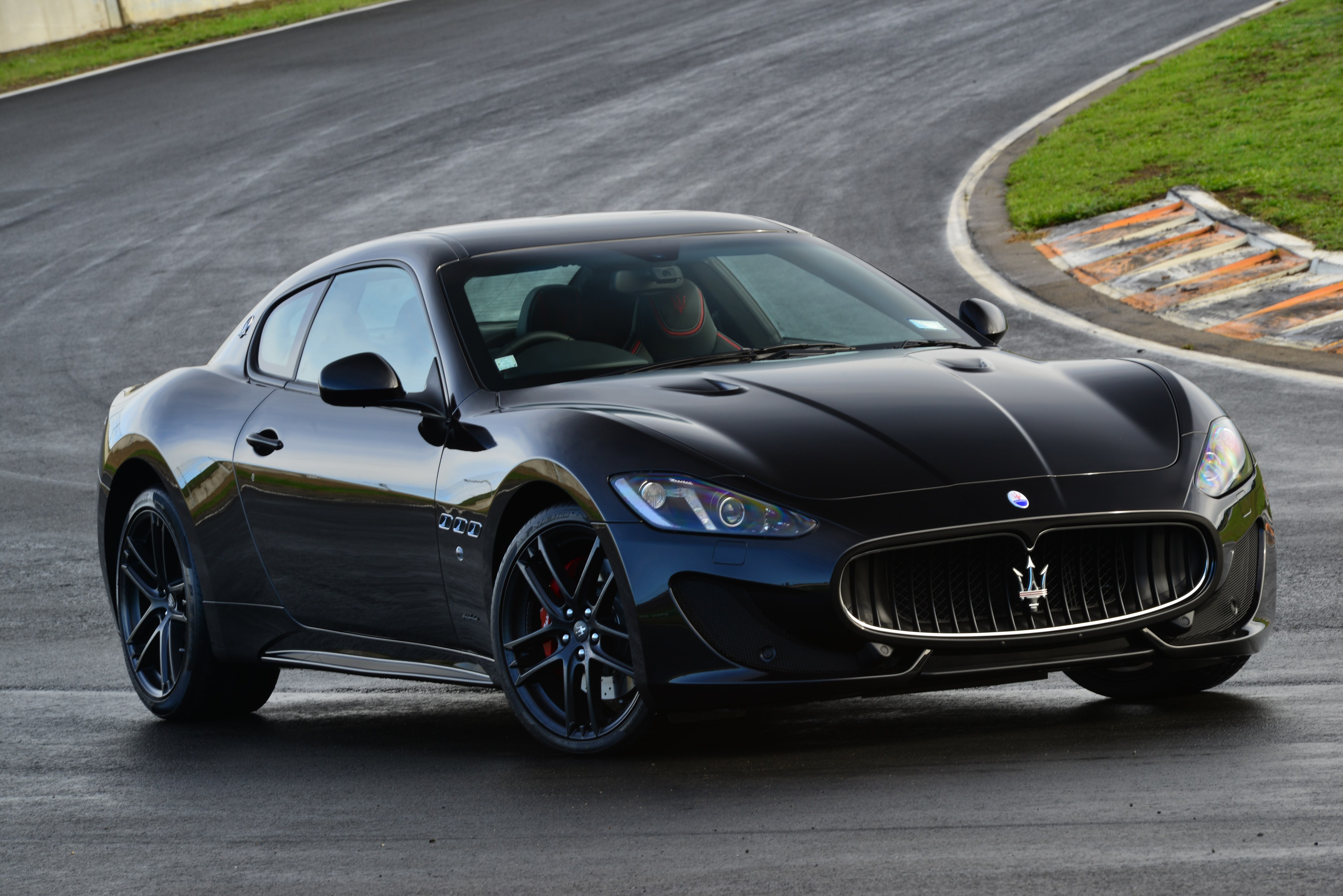 Black Maserati on a racetrack