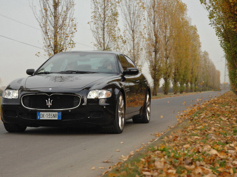 Black Maserati on autumn road