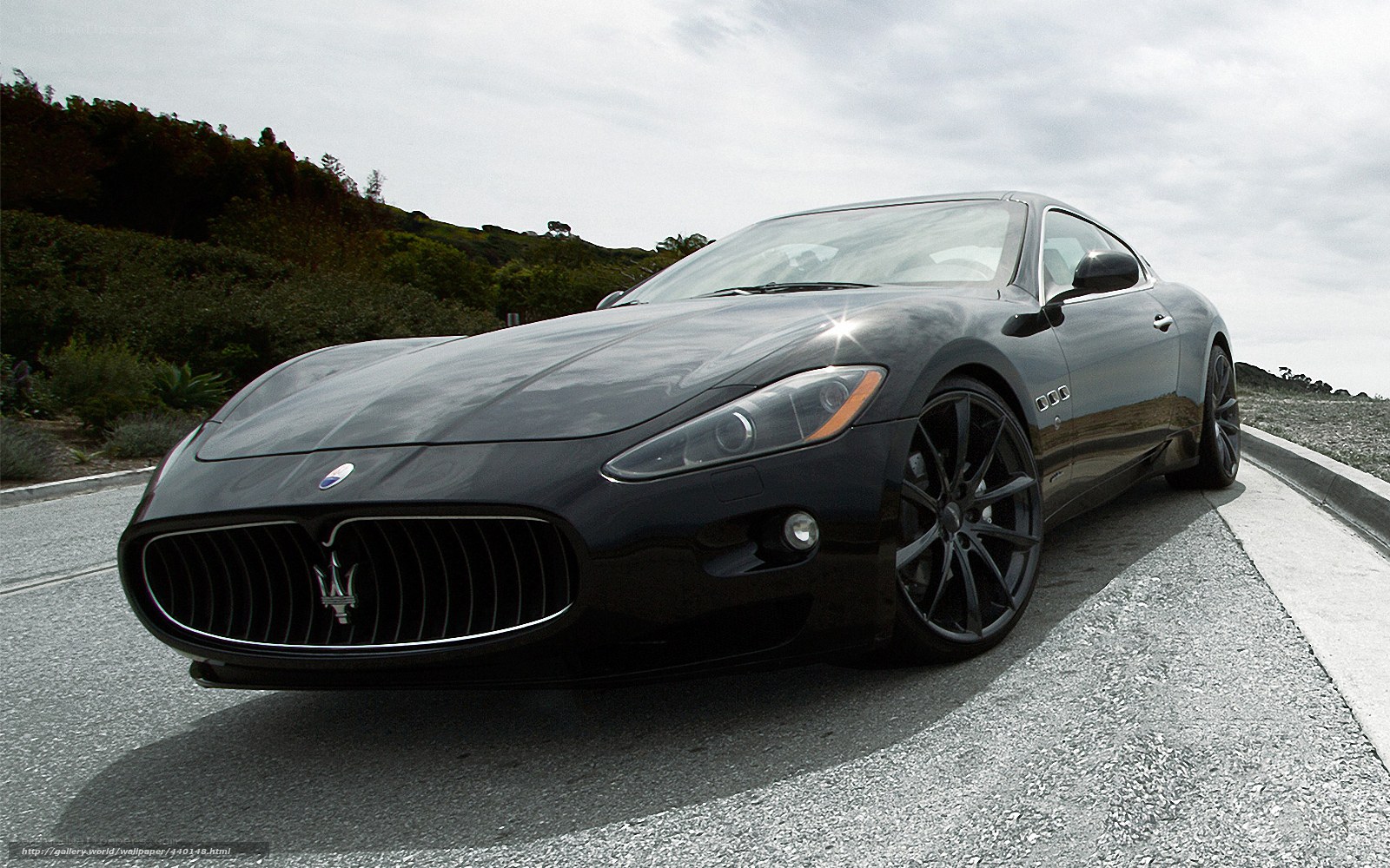 Black Maserati on coastal road