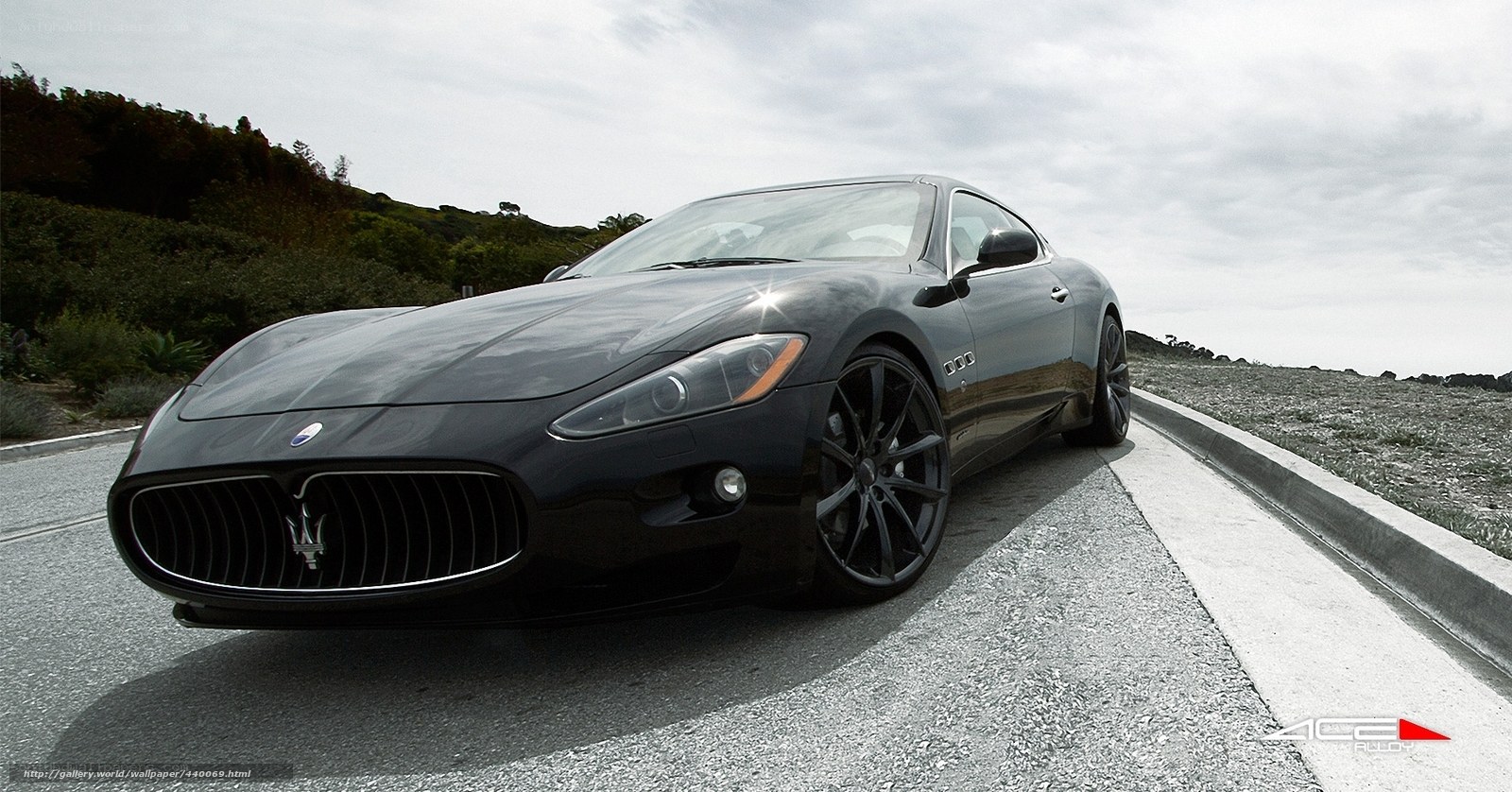 Black Maserati on coastal road