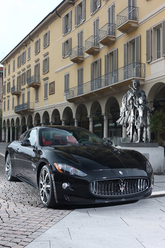 Black Maserati on cobblestone street