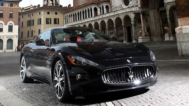 Black Maserati on cobblestone street