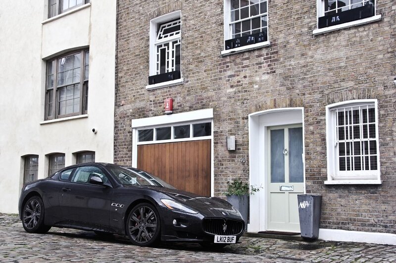 Black Maserati on cobblestone street