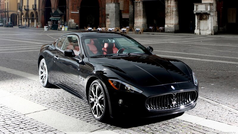 Black Maserati on cobblestone street