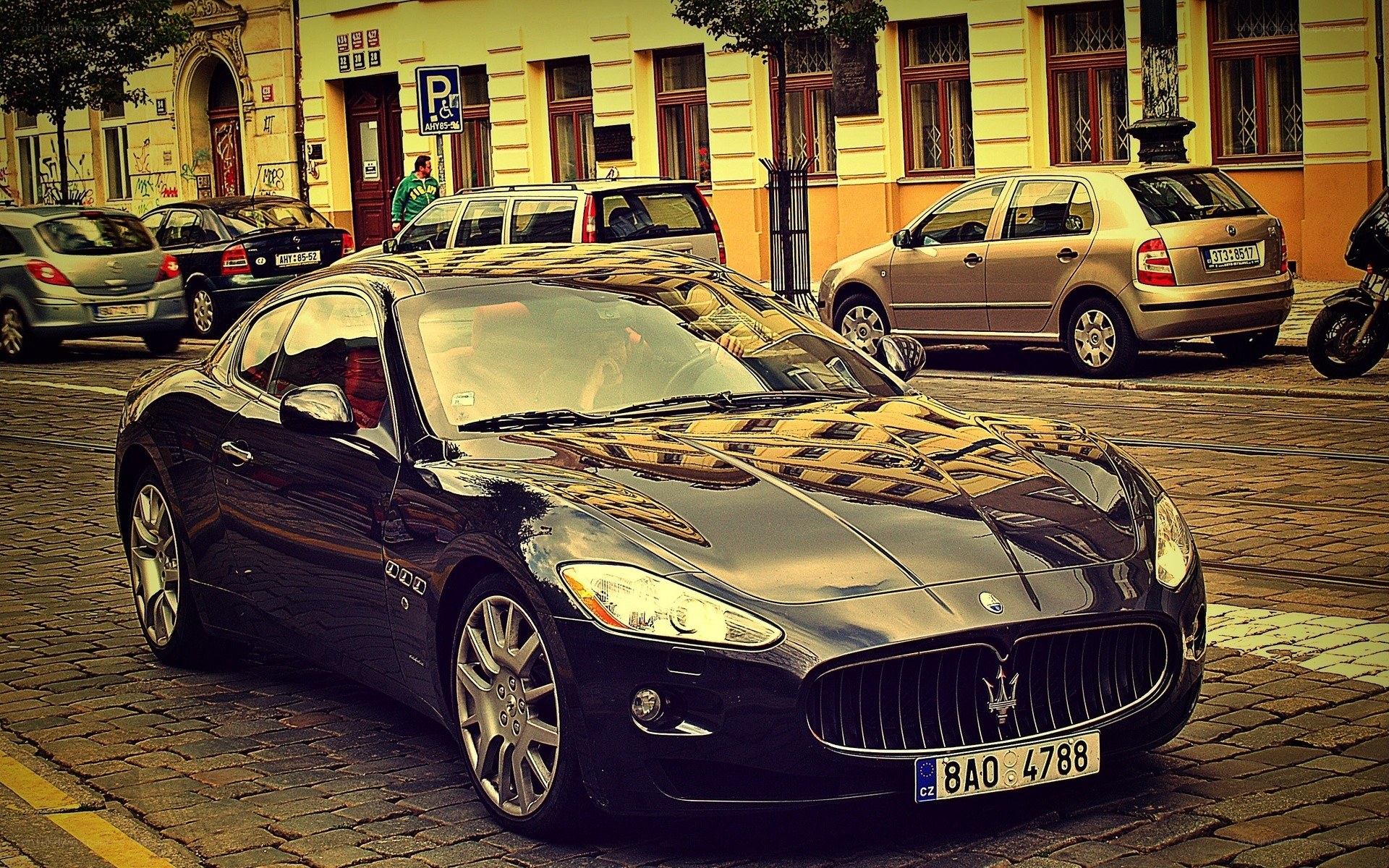 Black Maserati on cobblestone street