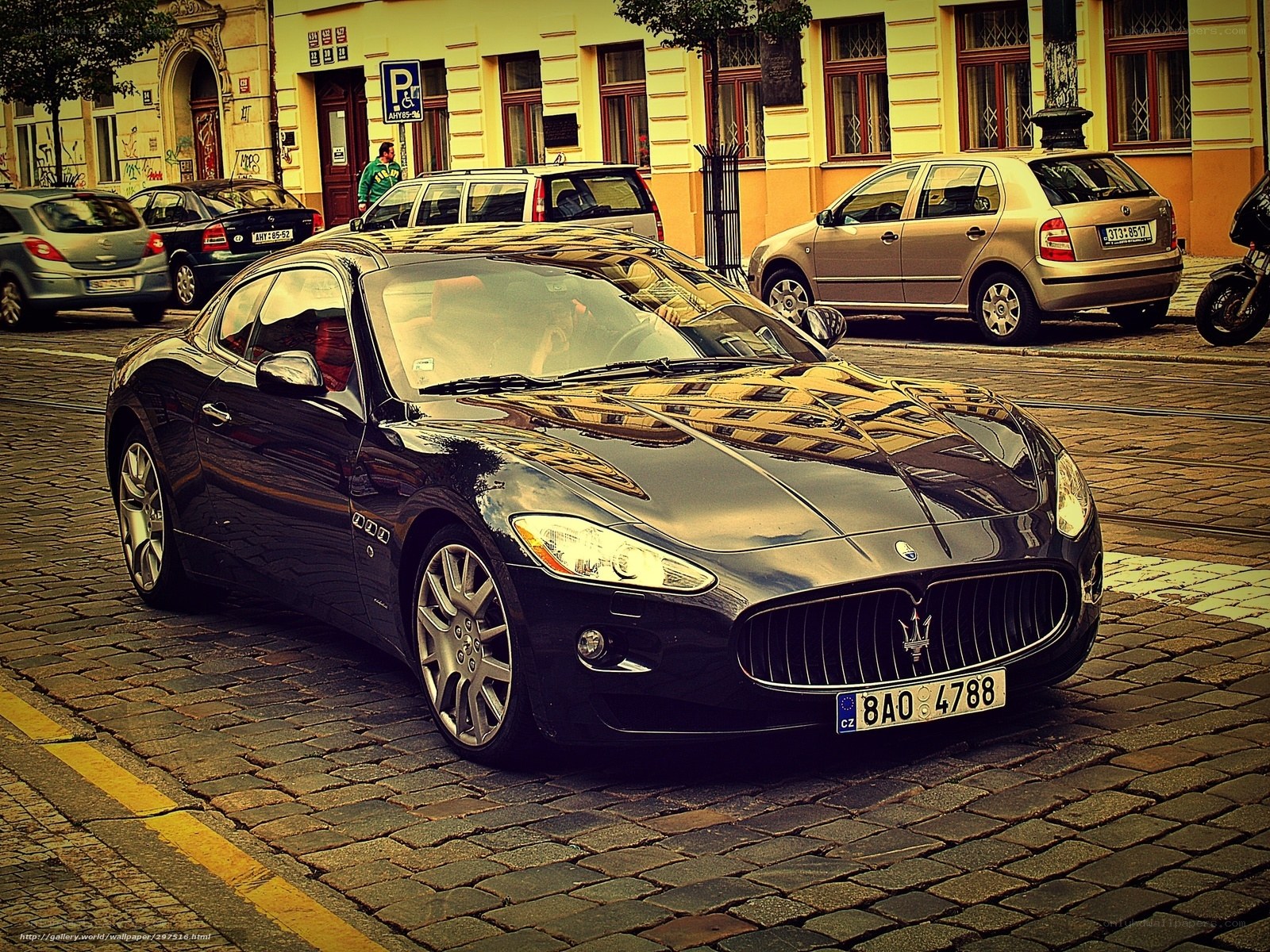 Black Maserati on cobblestone street
