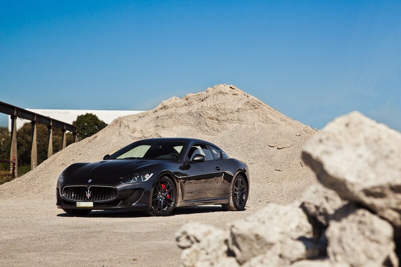 Black Maserati on gravel