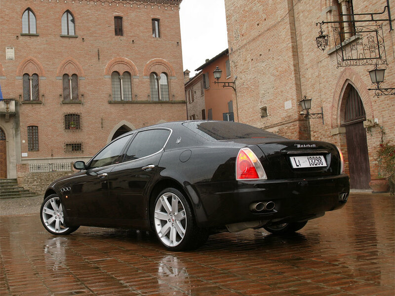 Black Maserati on wet street