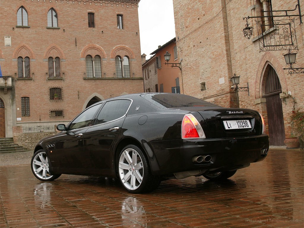 Black Maserati on wet street