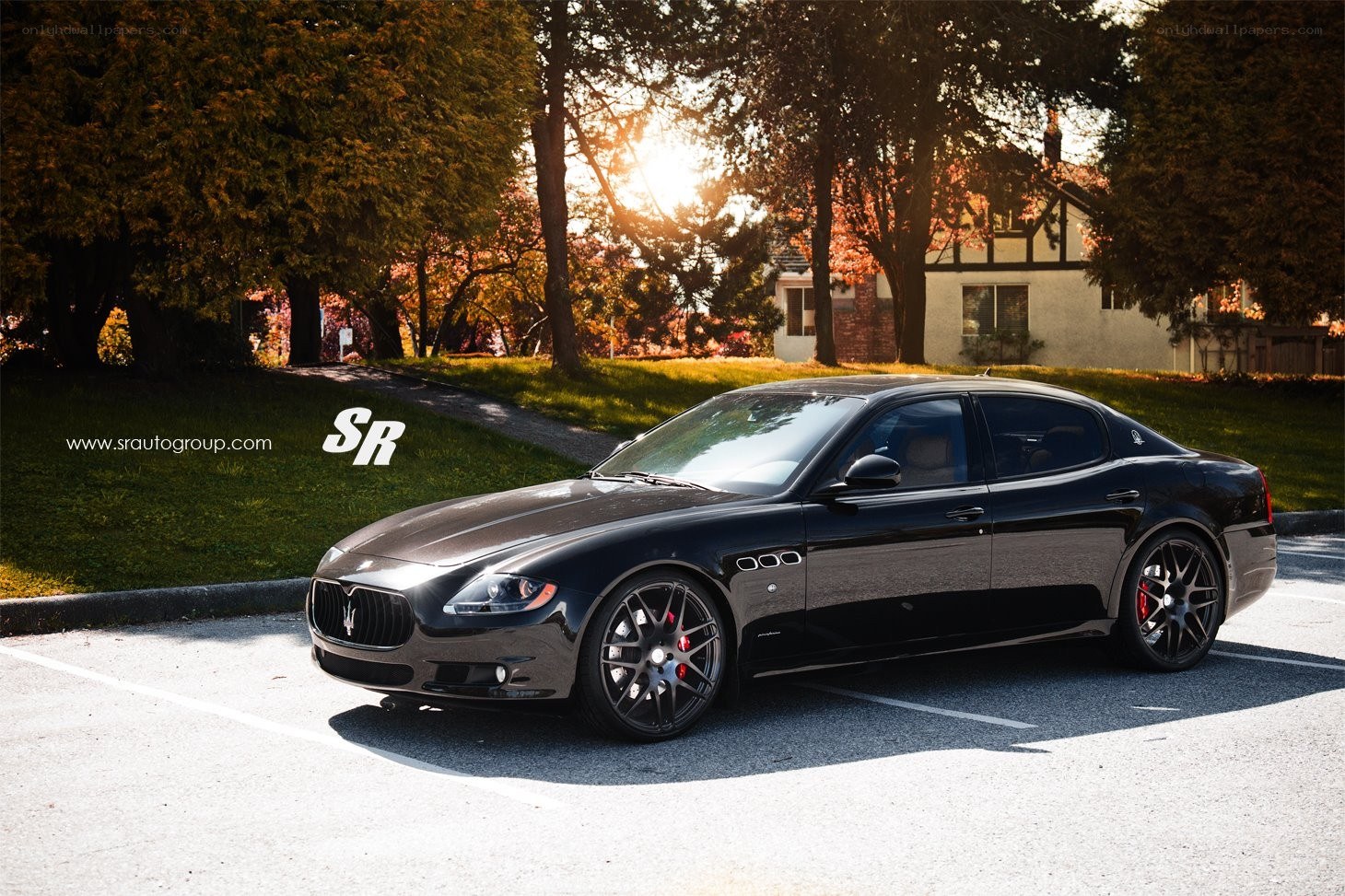 Black Maserati parked at sunset
