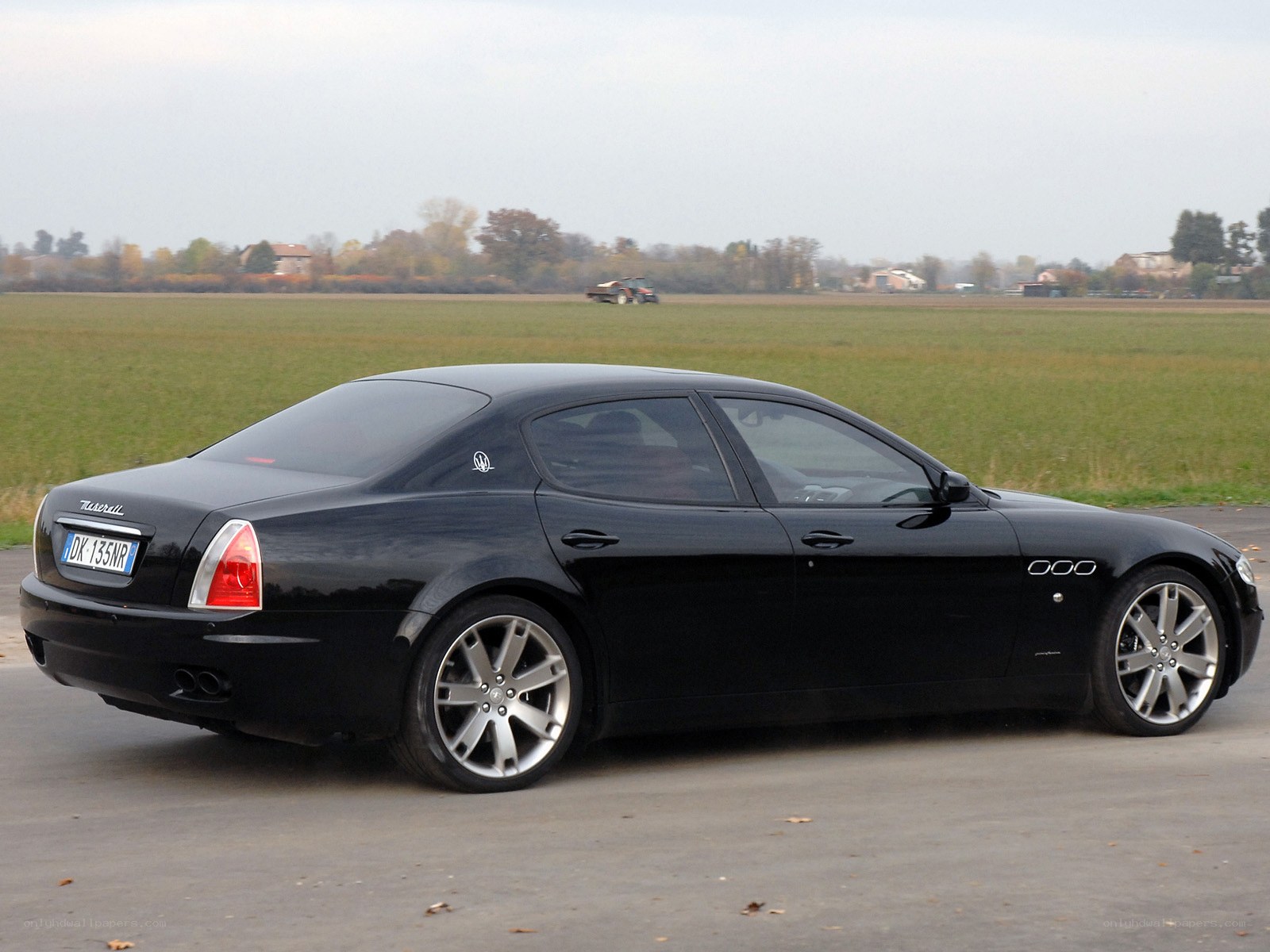 Black Maserati parked on pavement