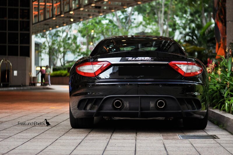 Black Maserati parked outside hotel